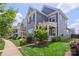 A street view featuring two-story homes, well-manicured lawns, and lush landscaping at 13714 Jacks Ln, Pineville, NC 28134