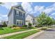 A street view of a two-story home featuring well-manicured lawn and lush landscaping at 13714 Jacks Ln, Pineville, NC 28134