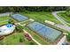 Aerial view of the tennis courts with lush green landscaping at 13714 Jacks Ln, Pineville, NC 28134