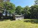 Backyard shed features a ramp for easy access and is surrounded by lush green trees offering plenty of shade at 1495 Carson Rd, Cleveland, NC 27013