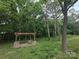 Beautiful backyard boasts a custom pergola with fire pit sitting on top of a stone paver base at 1495 Carson Rd, Cleveland, NC 27013