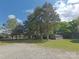 Large, gravel backyard with mature trees and a storage shed perfect for storing your outdoor equipment at 1495 Carson Rd, Cleveland, NC 27013