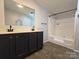 Bathroom featuring a double sink vanity, large mirror, and shower-tub combination at 1495 Carson Rd, Cleveland, NC 27013