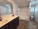Bright bathroom showcasing a double vanity, and a tub-shower combination at 1495 Carson Rd, Cleveland, NC 27013