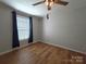 Bedroom with wood-look floors, ceiling fan and large window providing natural light at 1495 Carson Rd, Cleveland, NC 27013
