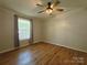 Bedroom featuring wood-look floors, a ceiling fan, and a bright window at 1495 Carson Rd, Cleveland, NC 27013