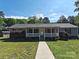 Inviting single-story home featuring a classic front porch and walkway through the green front lawn at 1495 Carson Rd, Cleveland, NC 27013