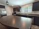 Well-lit kitchen features dark cabinets, stainless steel appliances, and a large island perfect for entertaining at 1495 Carson Rd, Cleveland, NC 27013