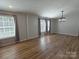 Spacious living room with wood floors, large windows, and modern light fixture at 1495 Carson Rd, Cleveland, NC 27013