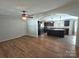Open living room with dark kitchen cabinets and laminate floors at 1495 Carson Rd, Cleveland, NC 27013