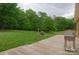 Outdoor deck with grill overlooking a big backyard filled with trees and greenery at 15027 Beatties Ford Rd, Huntersville, NC 28078