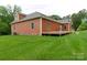 A view of a home featuring shingle siding, with a large wooden deck and grassy yard at 15027 Beatties Ford Rd, Huntersville, NC 28078