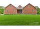 Charming home featuring a well-manicured lawn, shingle siding and stone foundation at 15027 Beatties Ford Rd, Huntersville, NC 28078