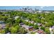 Expansive aerial view showing the neighborhood homes nestled among lush greenery with the city skyline in the background at 1512 Seigle Ave # 2, Charlotte, NC 28205