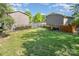 Well-kept backyard featuring a neat lawn, fencing, and access to apartment buildings on a sunny day at 1512 Seigle Ave # 2, Charlotte, NC 28205