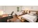 Bedroom featuring two beds, wood floors, ample natural light, and a dedicated workspace at 1512 Seigle Ave # 2, Charlotte, NC 28205