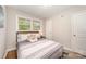 Brightly lit primary bedroom with hardwood floors and a ceiling fan at 1512 Seigle Ave # 2, Charlotte, NC 28205