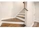 Hardwood staircase featuring white risers and walls and a landing at 1512 Seigle Ave # 2, Charlotte, NC 28205