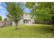 Picture of fenced backyard with patio and view of siding and rear windows at 1525 Moss Creek Dr, Harrisburg, NC 28075