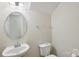 Neat half bathroom featuring a pedestal sink and standard toilet at 1525 Moss Creek Dr, Harrisburg, NC 28075