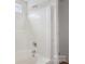 A clean white bathroom featuring a tiled shower and tub with silver fixtures at 1525 Moss Creek Dr, Harrisburg, NC 28075