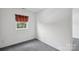 A room with neutral walls, carpeting and natural light from a window at 1525 Moss Creek Dr, Harrisburg, NC 28075