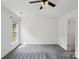 Open, carpeted bedroom with natural light from a large window at 1525 Moss Creek Dr, Harrisburg, NC 28075