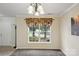 Bright dining room with a view, neutral decor, and comfortable carpeting at 1525 Moss Creek Dr, Harrisburg, NC 28075