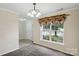 Bright dining room with large windows and neutral decor, perfect for Gathering meals at 1525 Moss Creek Dr, Harrisburg, NC 28075