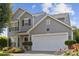 Charming two-story home features a two-car garage, well-maintained lawn, and beautiful landscaping at 1525 Moss Creek Dr, Harrisburg, NC 28075