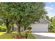 Charming home with mature landscaping, a welcoming front porch, and a two-car garage at 1525 Moss Creek Dr, Harrisburg, NC 28075