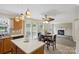 Open concept kitchen seamlessly flows into the living room featuring natural light and modern design at 1525 Moss Creek Dr, Harrisburg, NC 28075