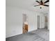 Large carpeted main bedroom showing ensuite bathroom and closet entrances at 1525 Moss Creek Dr, Harrisburg, NC 28075