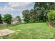 Large grass backyard with trees and split rail fence at 16017 Woodcote Dr, Huntersville, NC 28078