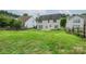 Expansive backyard featuring lush greenery and patio, ideal for outdoor entertaining at 16017 Woodcote Dr, Huntersville, NC 28078