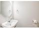 Powder room with an octagon mirror and a pedestal sink, perfect for guests at 16017 Woodcote Dr, Huntersville, NC 28078