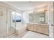 Bathroom with a tiled floor, double sink vanity, and separate tub and shower at 16017 Woodcote Dr, Huntersville, NC 28078