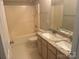 Bathroom featuring double sinks, granite countertops, bathtub and shower at 16017 Woodcote Dr, Huntersville, NC 28078