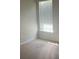 Bedroom with beige carpeting and a window allowing natural light to enter the room at 16017 Woodcote Dr, Huntersville, NC 28078