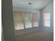 Bedroom featuring neutral carpeting and three windows with blinds at 16017 Woodcote Dr, Huntersville, NC 28078