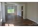 Inviting dining room with hardwood floors, large windows, and a seamless flow to the kitchen area at 16017 Woodcote Dr, Huntersville, NC 28078