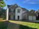 Charming two-story home with brick and vinyl siding, an attached two car garage, and a well-manicured lawn at 16017 Woodcote Dr, Huntersville, NC 28078