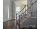Welcoming foyer with hardwood floors, staircase, and ample natural light creating an inviting entrance at 16017 Woodcote Dr, Huntersville, NC 28078