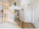 Bright foyer with hardwood floors, staircase with wood banister and white risers, and a two-story ceiling at 16017 Woodcote Dr, Huntersville, NC 28078