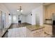Open kitchen design with granite countertops and a direct view into the living area with fireplace at 16017 Woodcote Dr, Huntersville, NC 28078