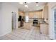Well-lit kitchen equipped with modern appliances, granite counters, tile flooring, and a convenient center island at 16017 Woodcote Dr, Huntersville, NC 28078