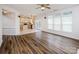 Open floor plan with hardwood flooring, connecting living room to the kitchen with an eat-in island at 16017 Woodcote Dr, Huntersville, NC 28078