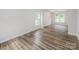 Spacious living room featuring wood flooring, two large windows and neutral wall color at 16017 Woodcote Dr, Huntersville, NC 28078