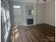 Bright living room featuring a fireplace, large windows, and elegant hardwood flooring at 16017 Woodcote Dr, Huntersville, NC 28078
