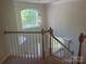 Staircase with chandelier and a large window allowing plenty of natural light to enter the home at 16017 Woodcote Dr, Huntersville, NC 28078